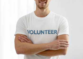 smiley-male-volunteer-posing-with-arms-crossed